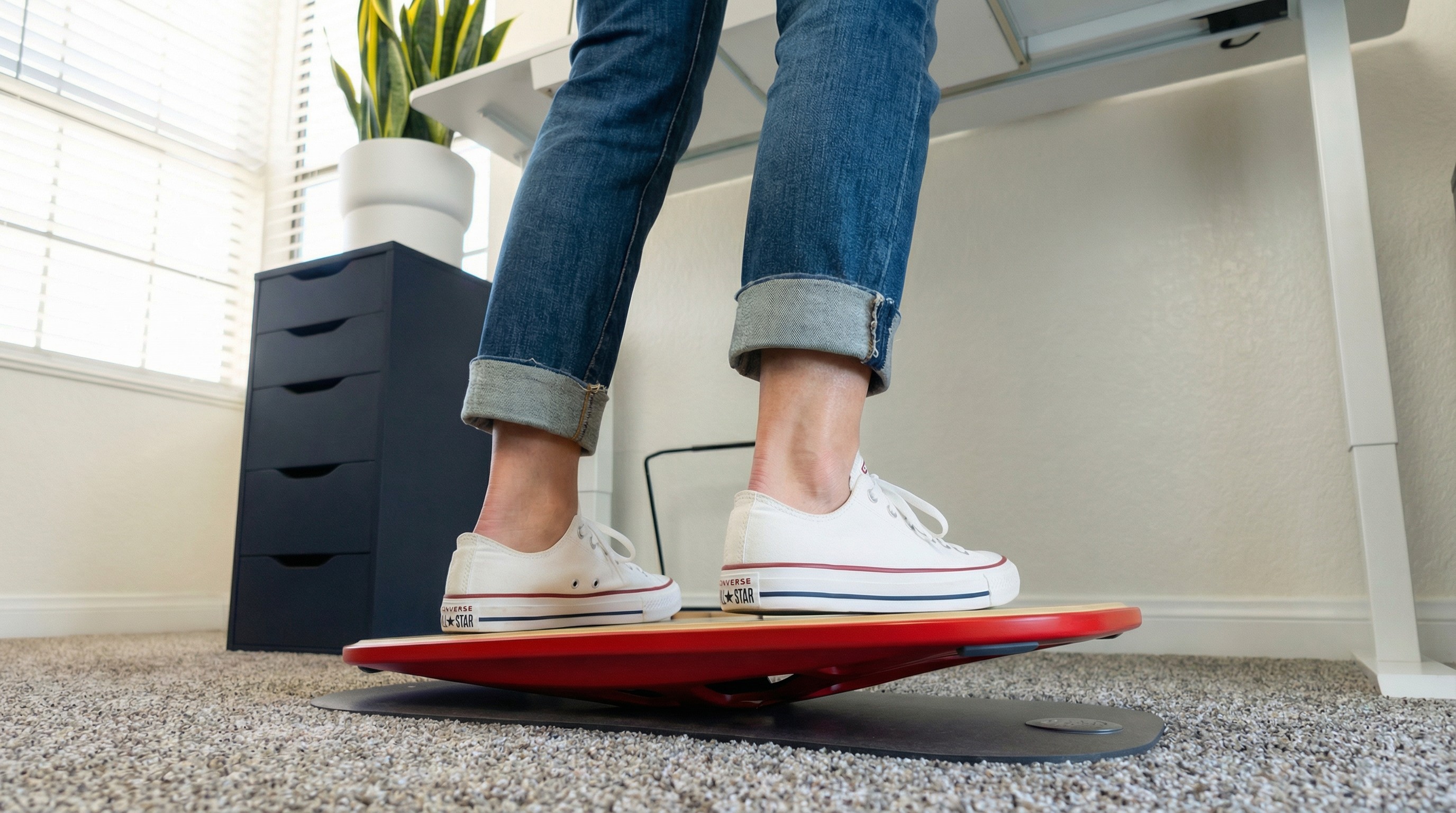 UGC. Red Balance Board. White Desk Setup.White Shoes and legs on board.jpg