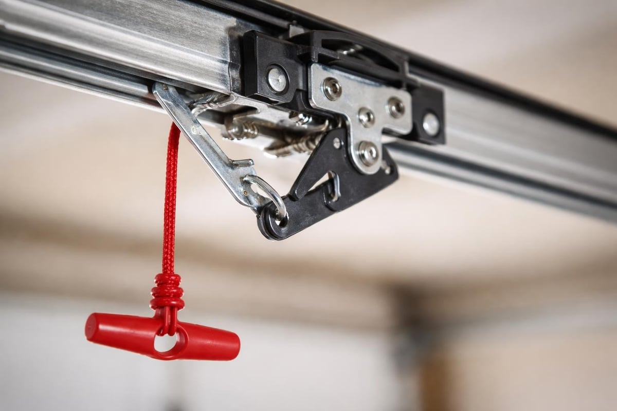 Manual garage door release mechanism
