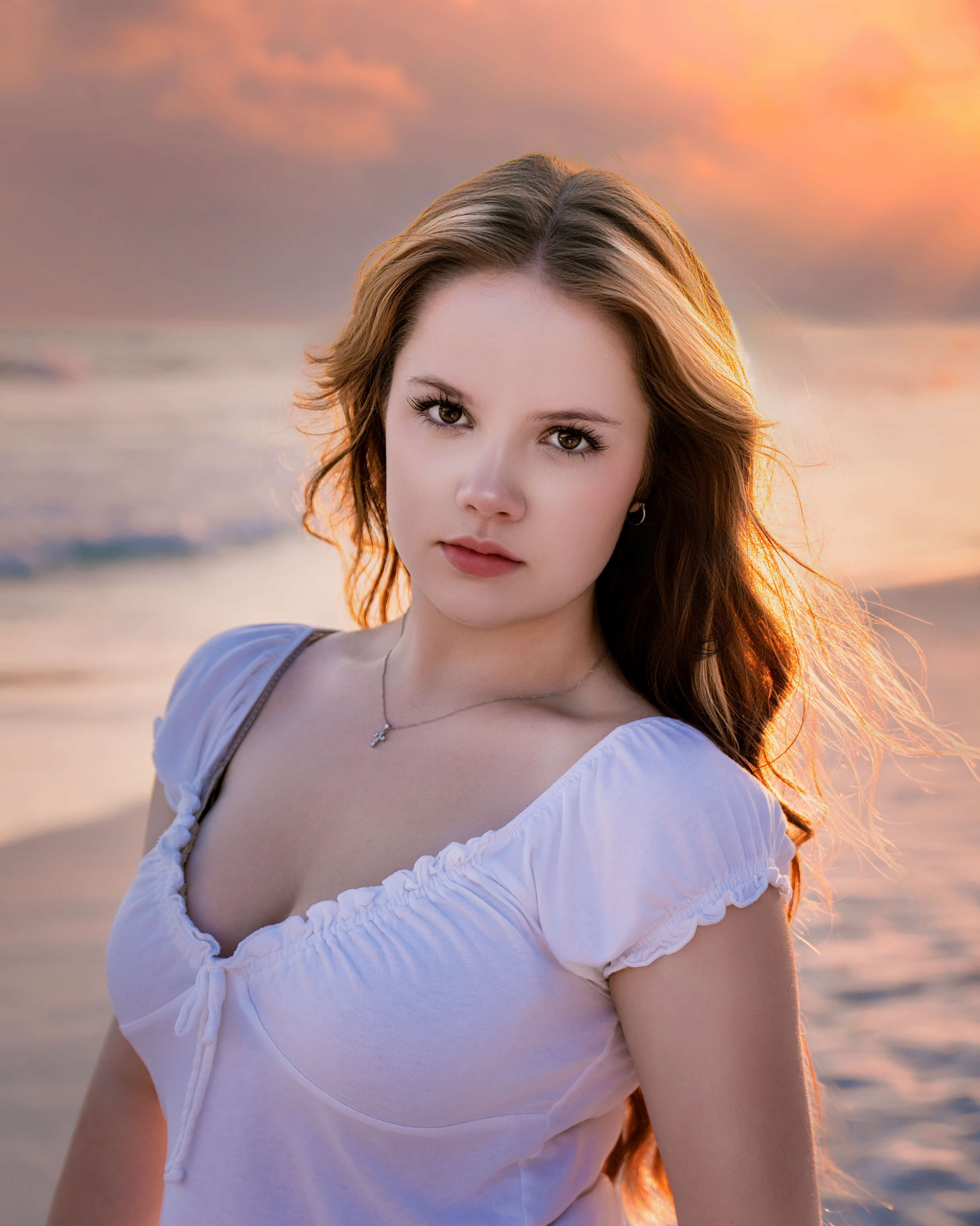 breanne-fine-portraiture-beach-family-child-heirloom-photgrapher-portrait-artist461.jpg The sunset glows in the windswept hair of a teenager on the beach in her senior portraits on the gulf coast as captured by Breanne Cook, of Breanne Fine Portraiture.